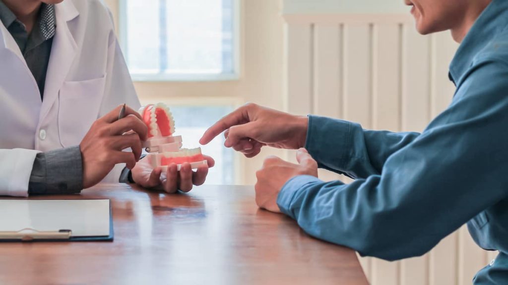 Dentist discussing treatment options with patient