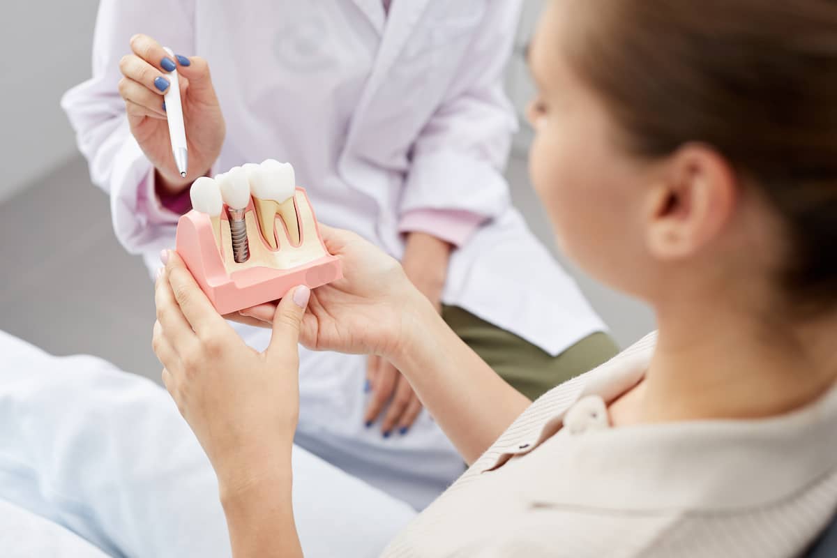 Dentist explains to patient how to care for dental implants