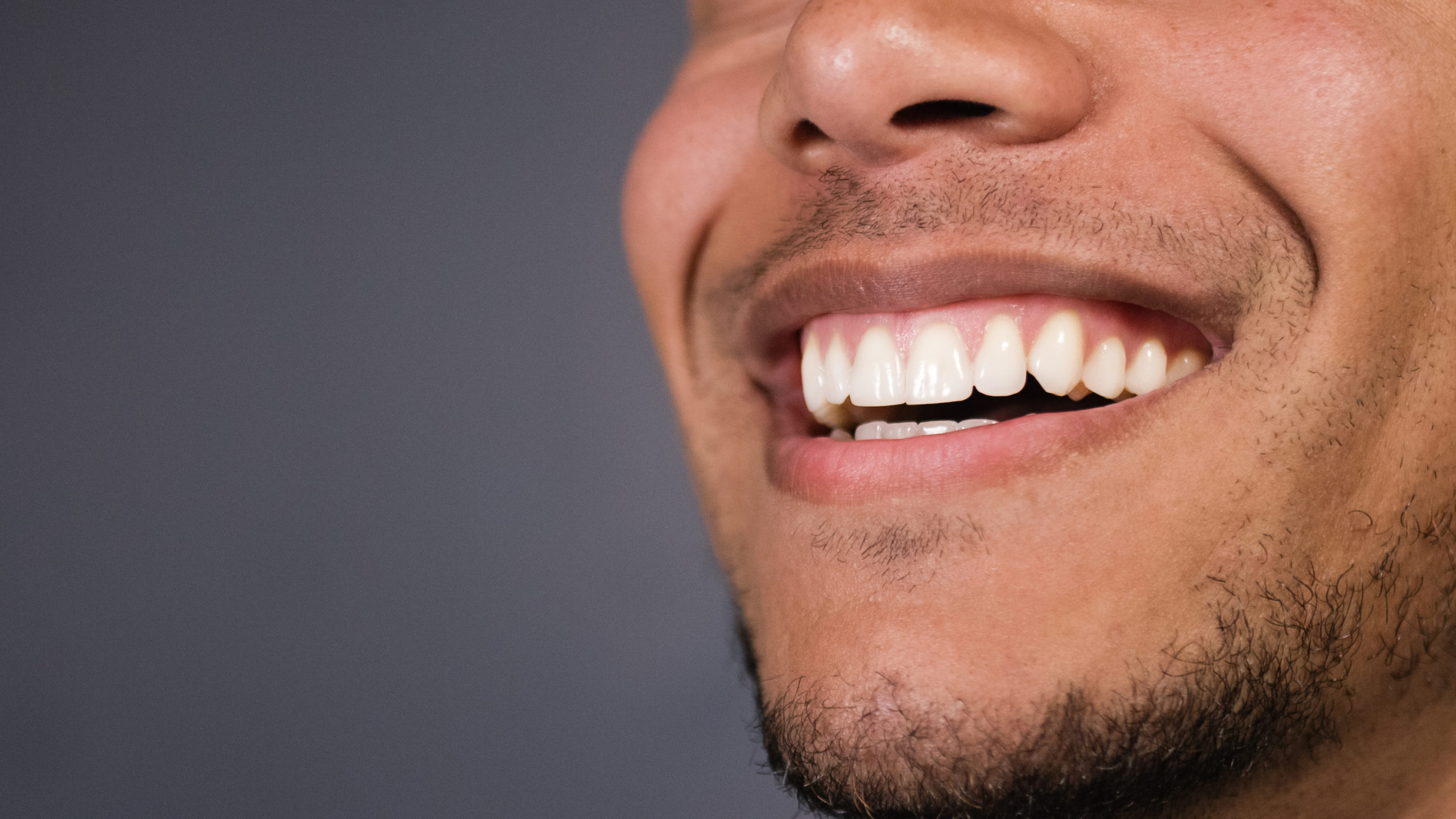 Healthy teeth of a male as he smiles at something