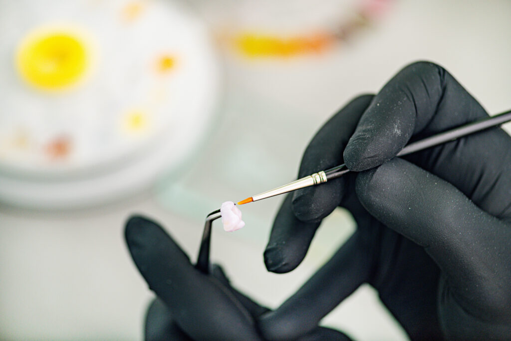 Dental Technician Preparing Ceramic Tooth Crown