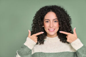 Happy young woman pointing at her dream smile