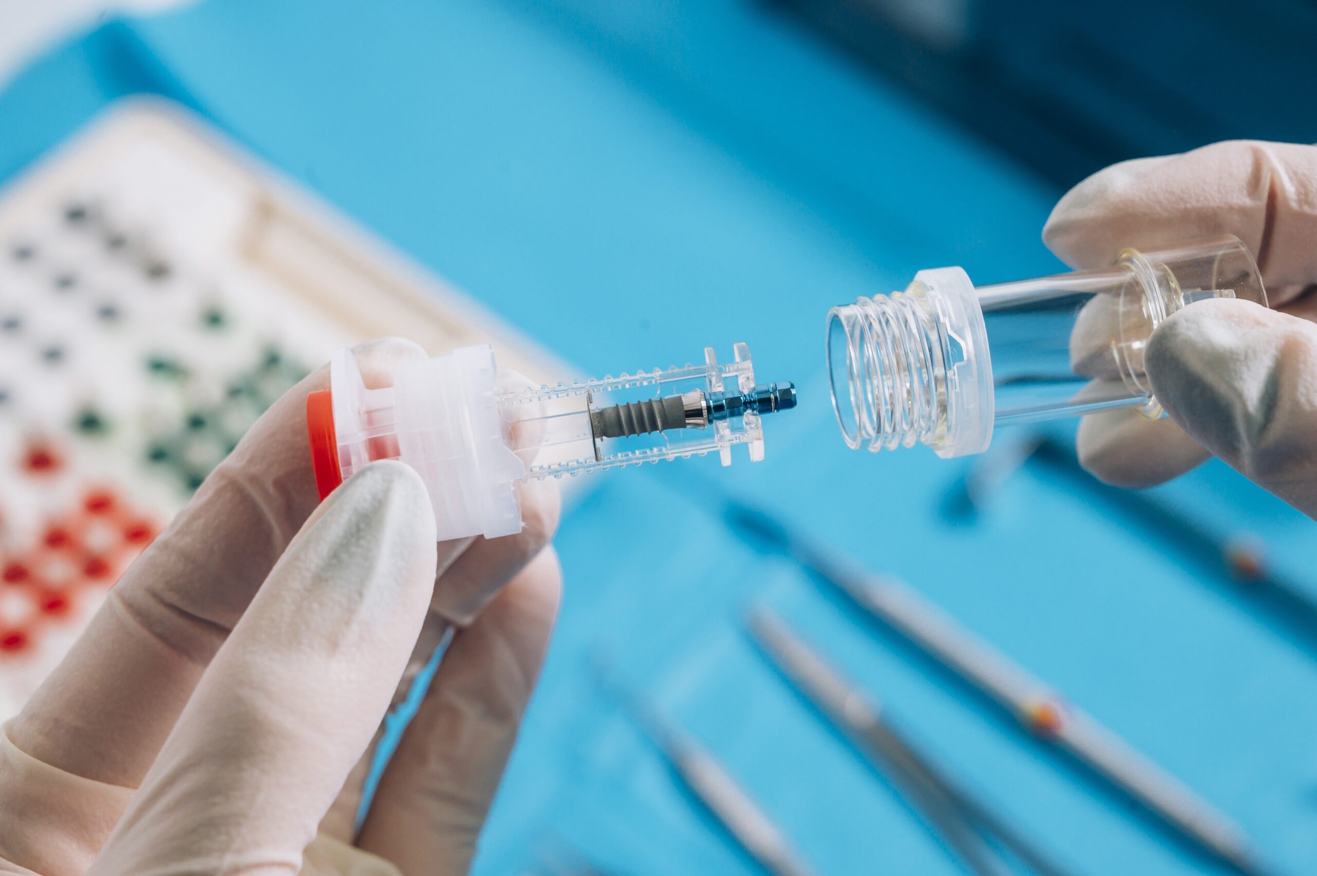 Implant failure; Hand holding a dental implant