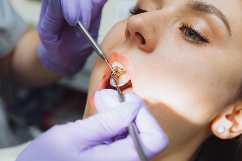 Young woman at the dentist with toothache after a filling